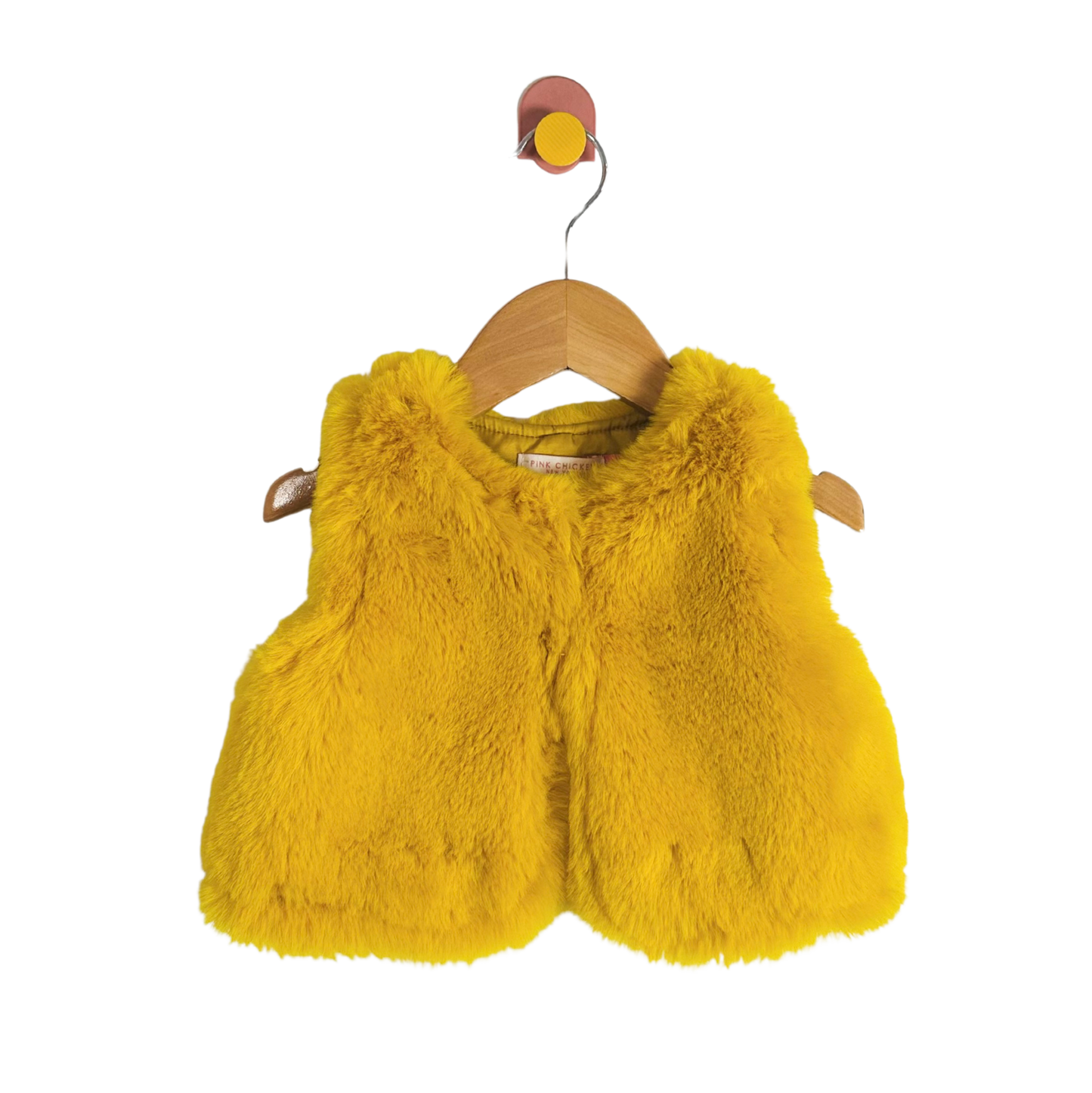 Yellow fluffy vest on a wooden hanger against a white background
