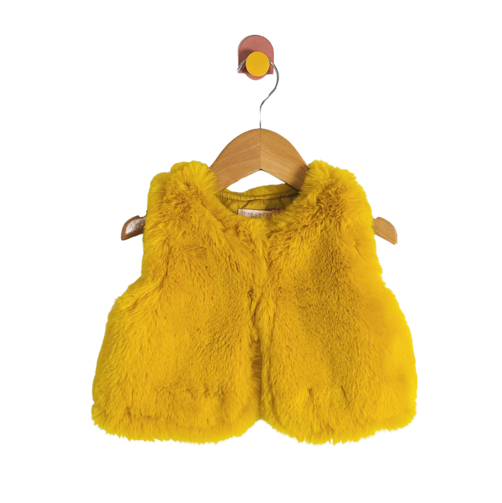 Yellow fluffy vest on a wooden hanger against a white background
