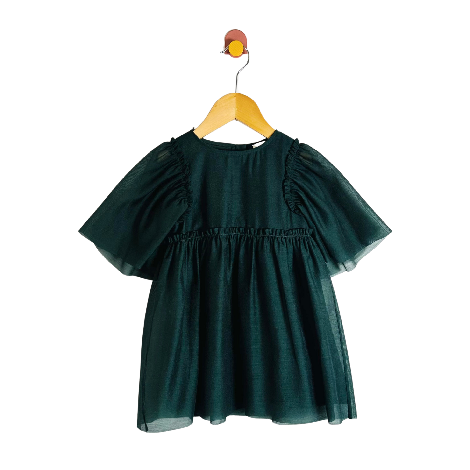 Green dress on a wooden hanger against a white background