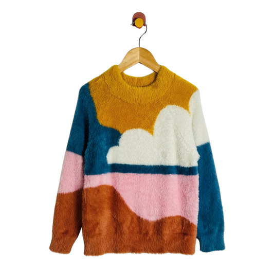 A fuzzy knit sweater with a cloud and landscape color-block pattern, hanging on a wooden hanger against a plain white background.