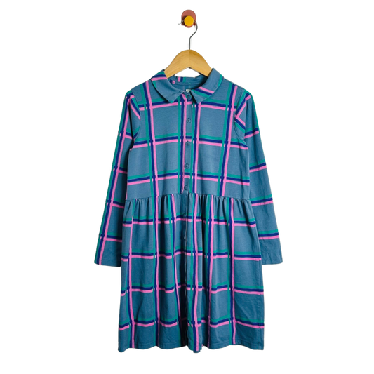 A long-sleeve plaid dress in teal blue with pink and green stripes, hanging on a wooden hanger against a plain white background.