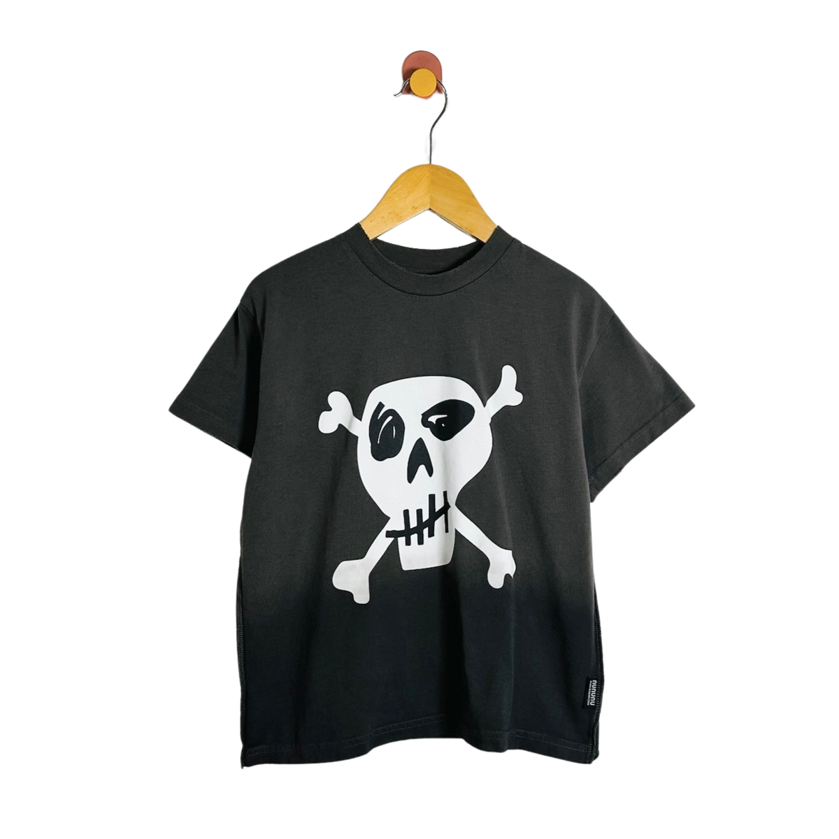 A black short-sleeve t-shirt with a white skull and crossbones graphic on the front, hanging on a wooden hanger against a plain white background.