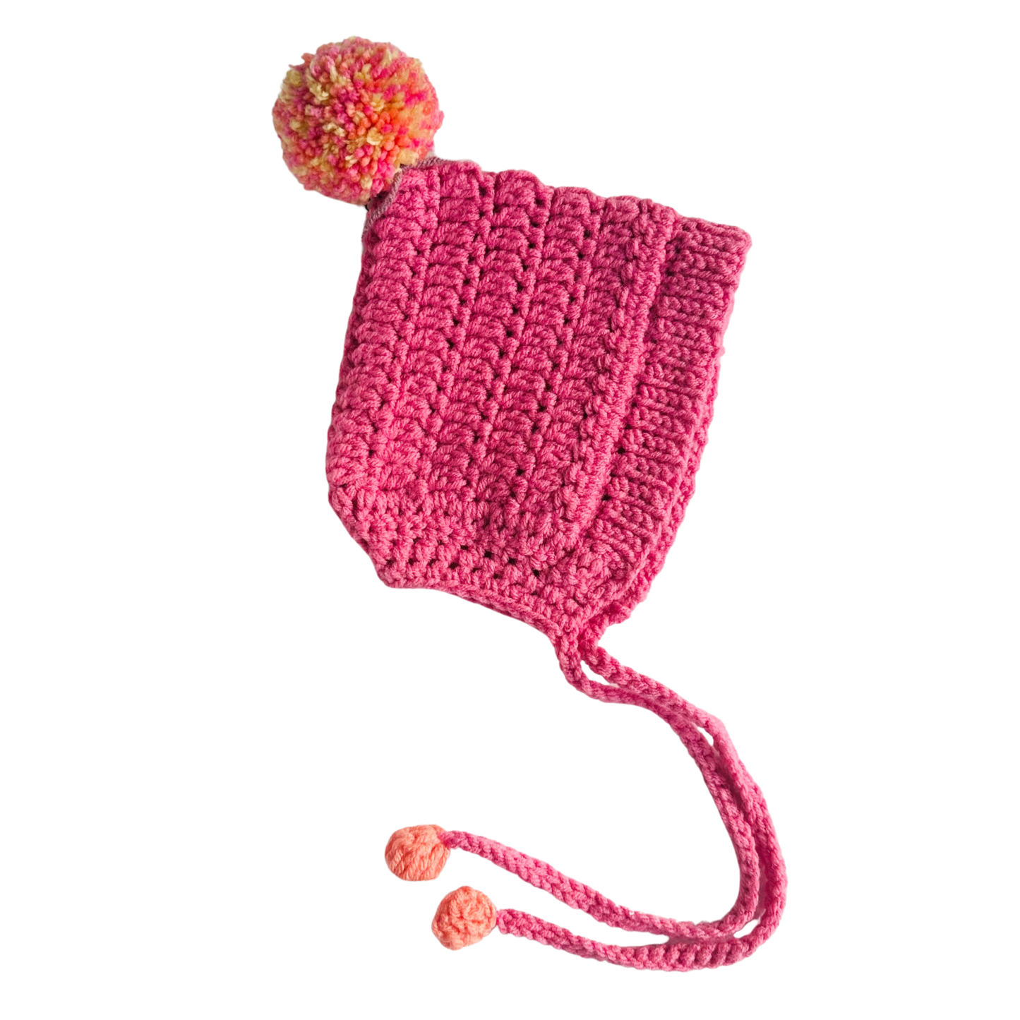 Pink knitted hat with a colorful pom-pom on a white background