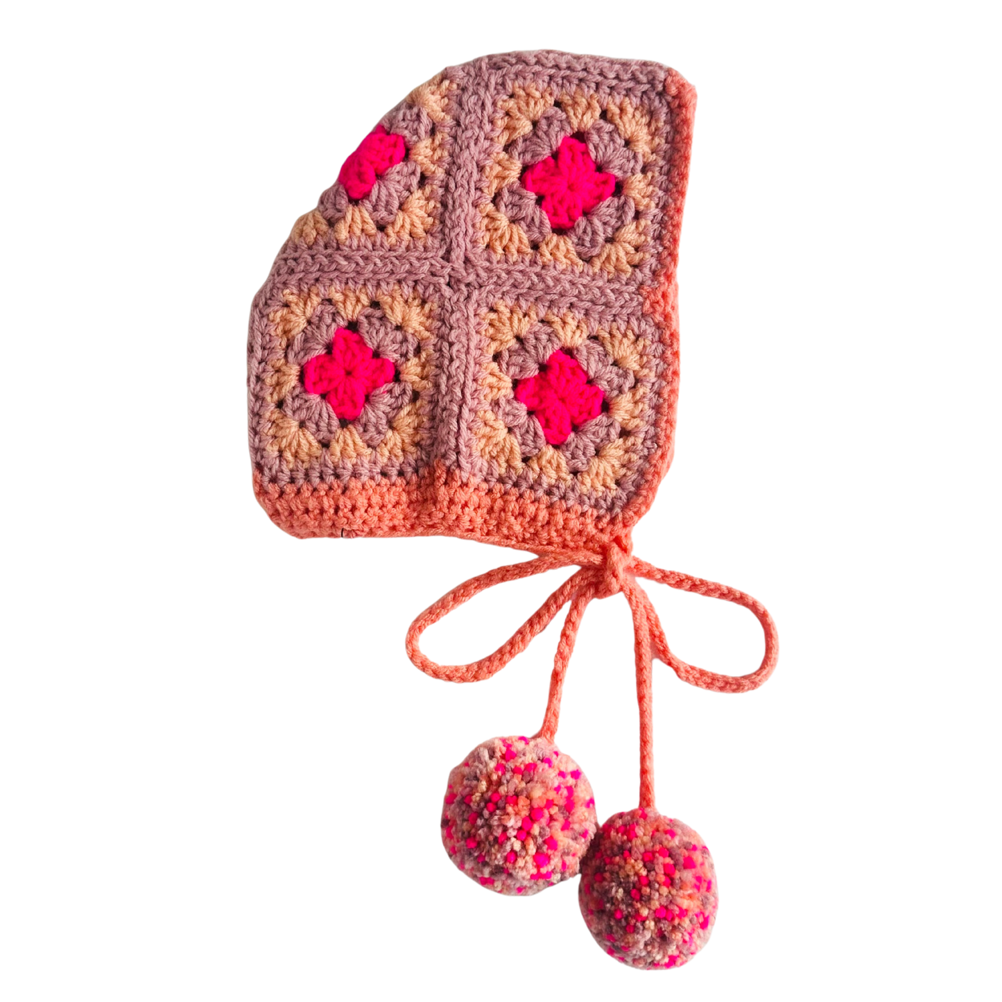 Crocheted baby bonnet with colorful squares and pom-poms on a white background