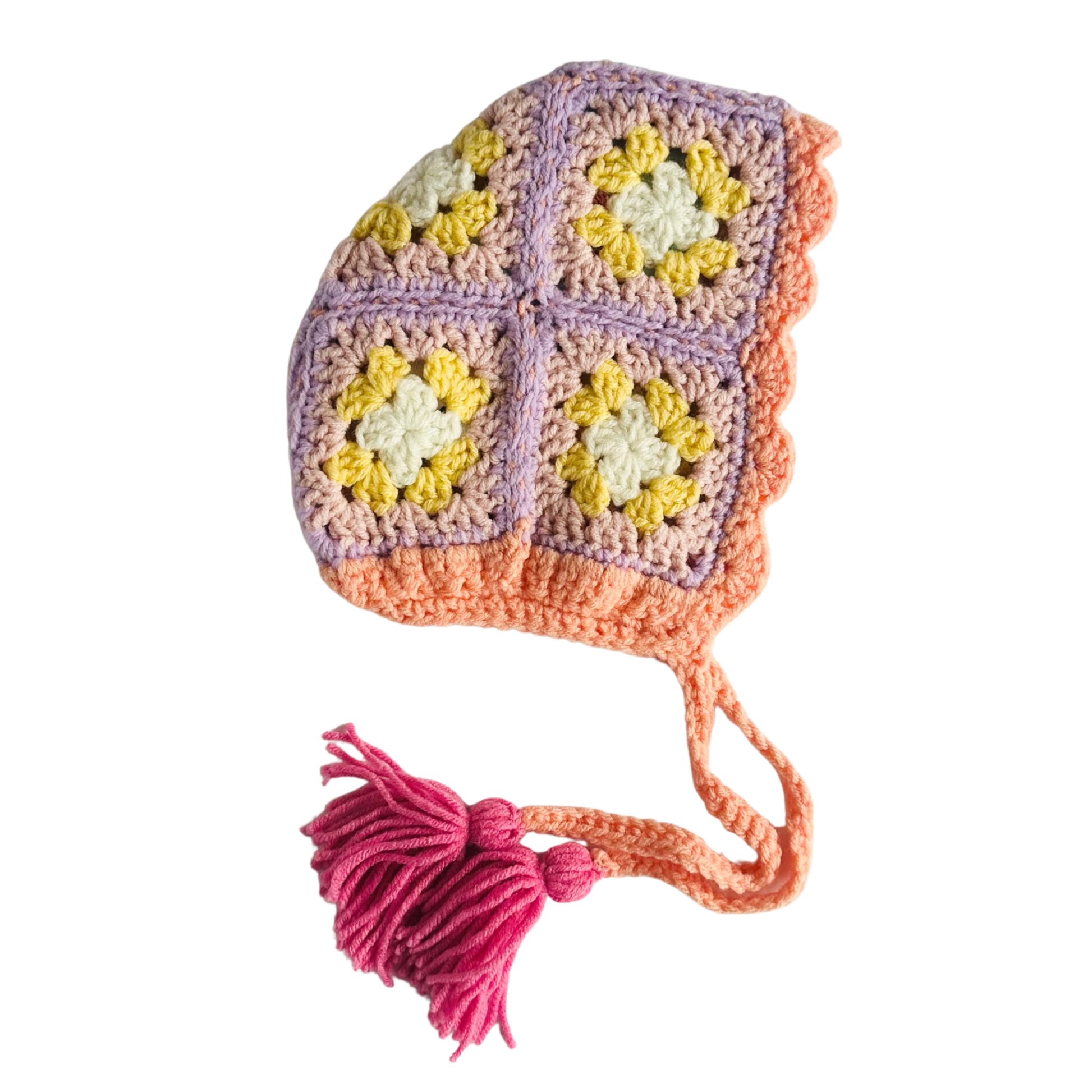Colorful crocheted baby hat with a tassel on a white background