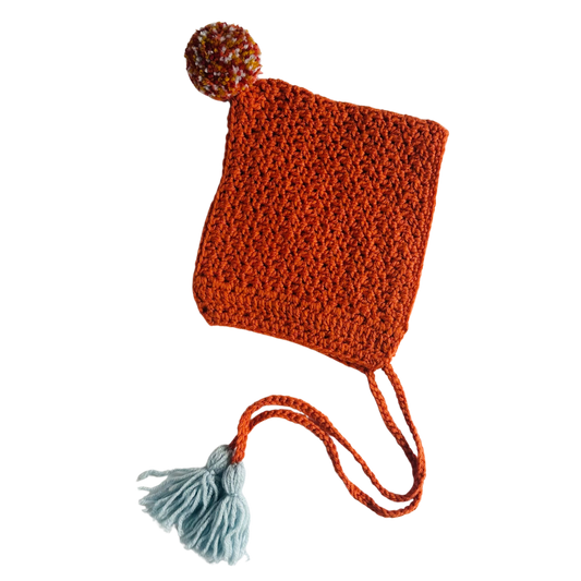 Knitted hat with a pom-pom on a white background