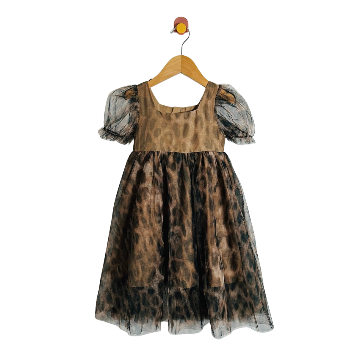 A children's dress with a brown and black leopard print pattern, featuring sheer puff sleeves, a square neckline, hanging on a wooden hanger against a plain white wall.