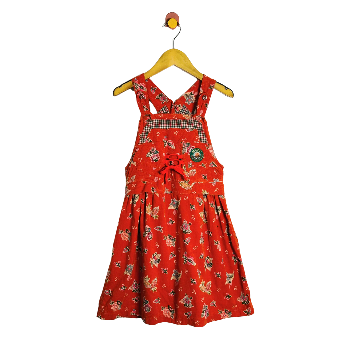 Red dress with a pattern on a hanger against a white background