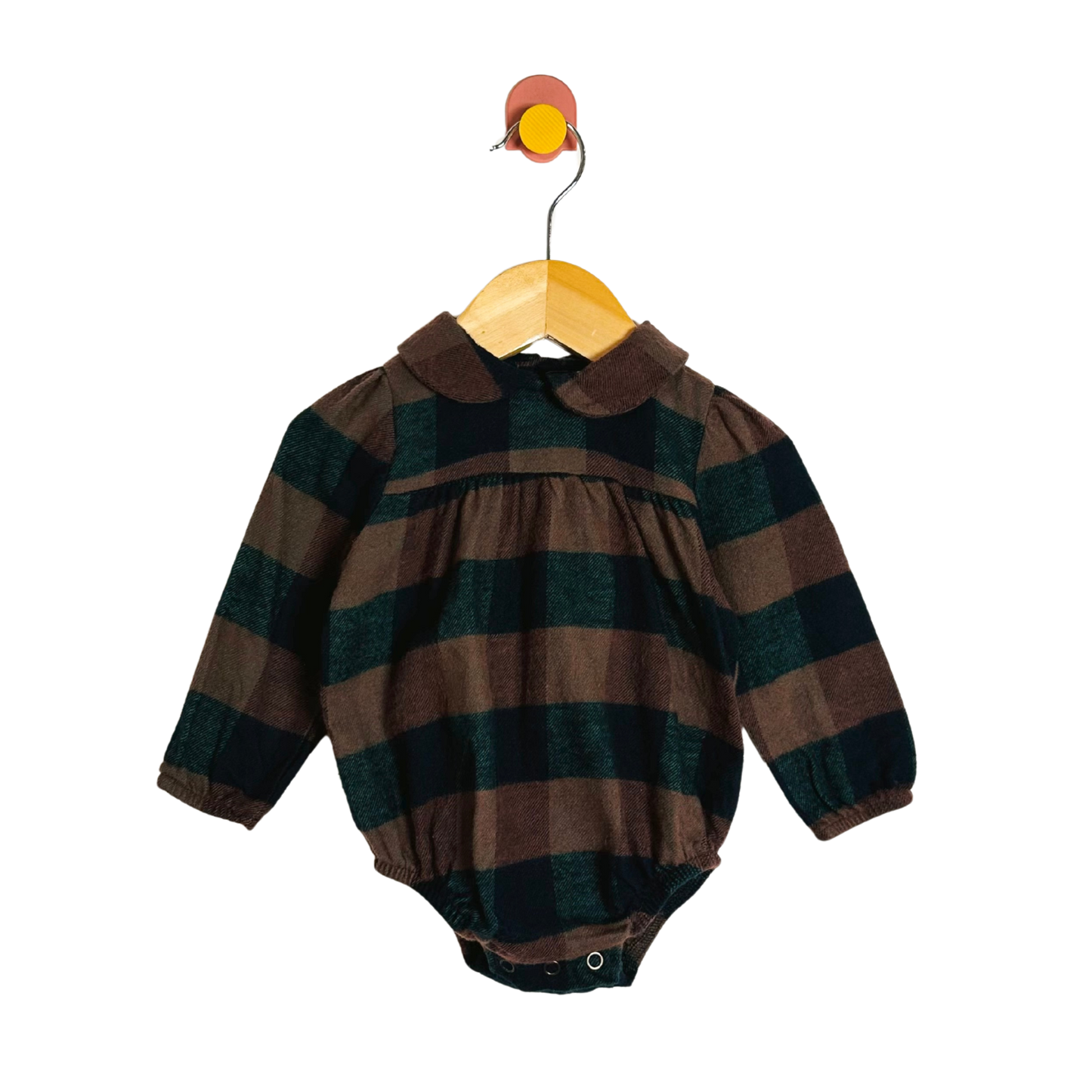 Plaid baby romper on a hanger against a white background