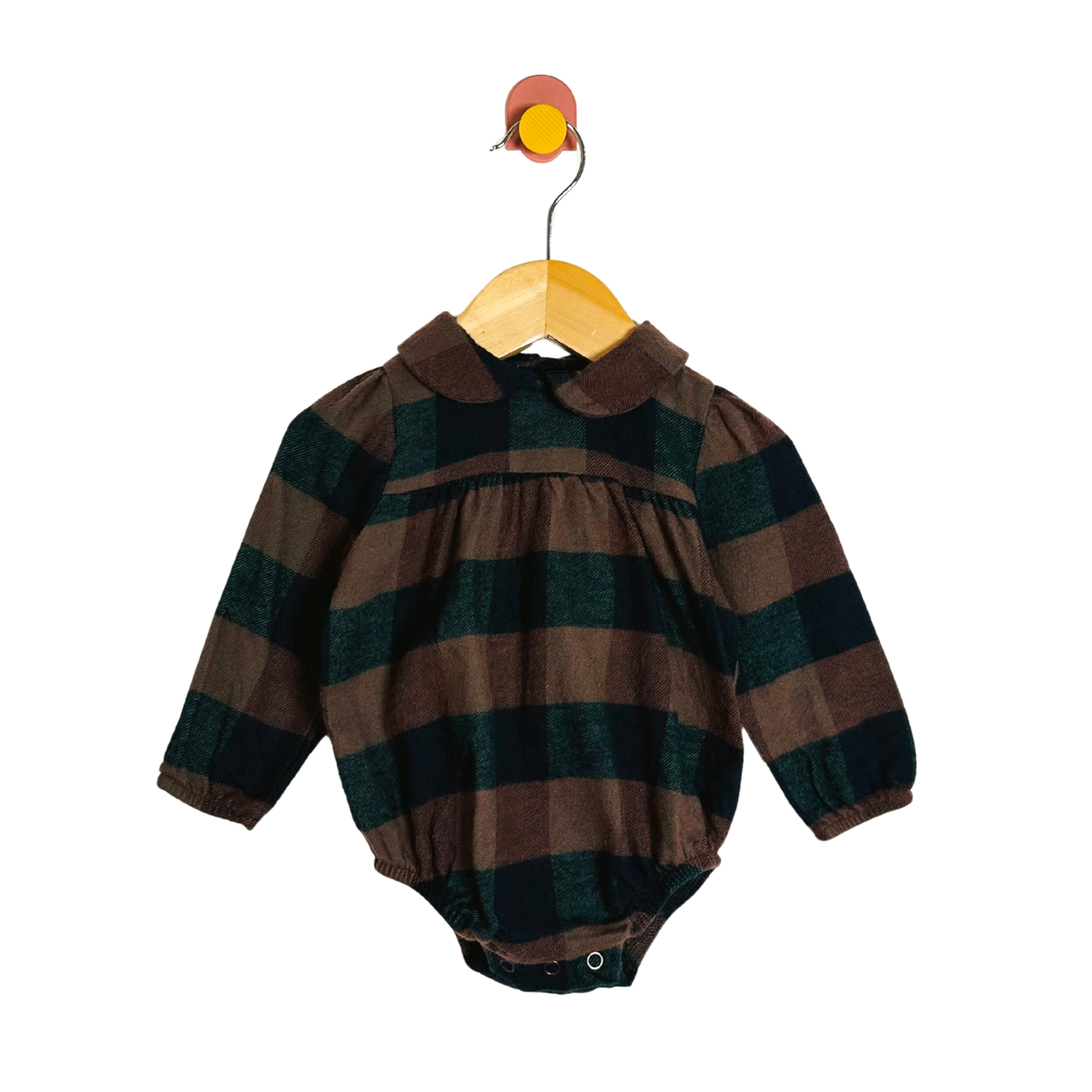 Plaid baby romper on a hanger against a white background