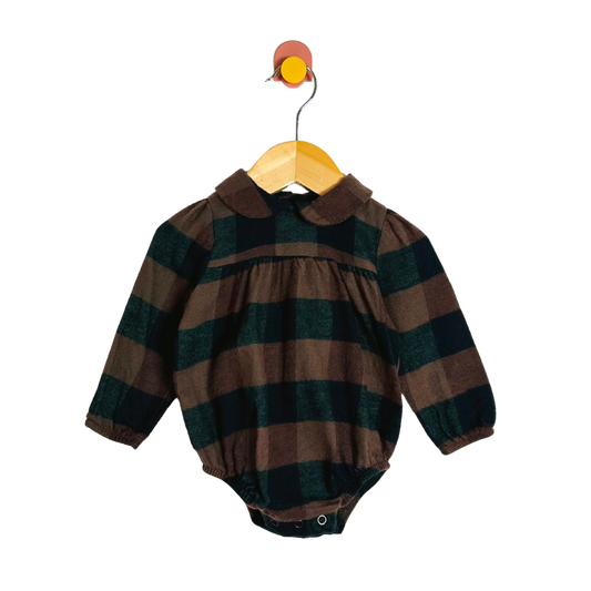 Plaid baby romper on a hanger against a white background