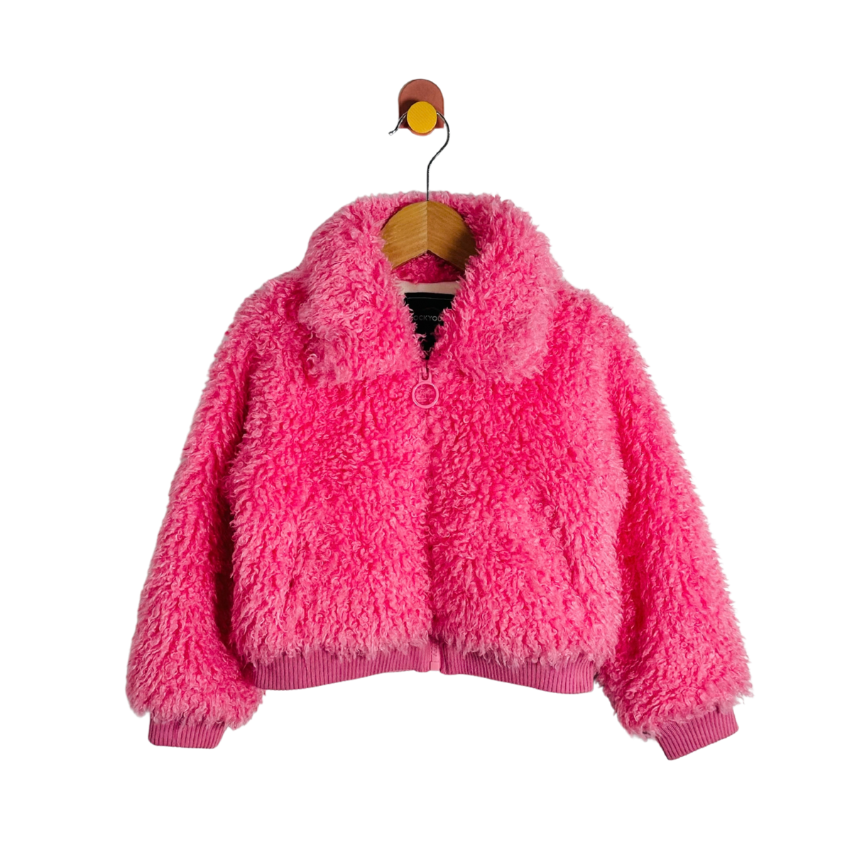 A bright pink fuzzy sherpa jacket with a ribbed collar, cuffs, and hem, hanging on a wooden hanger against a plain white background.