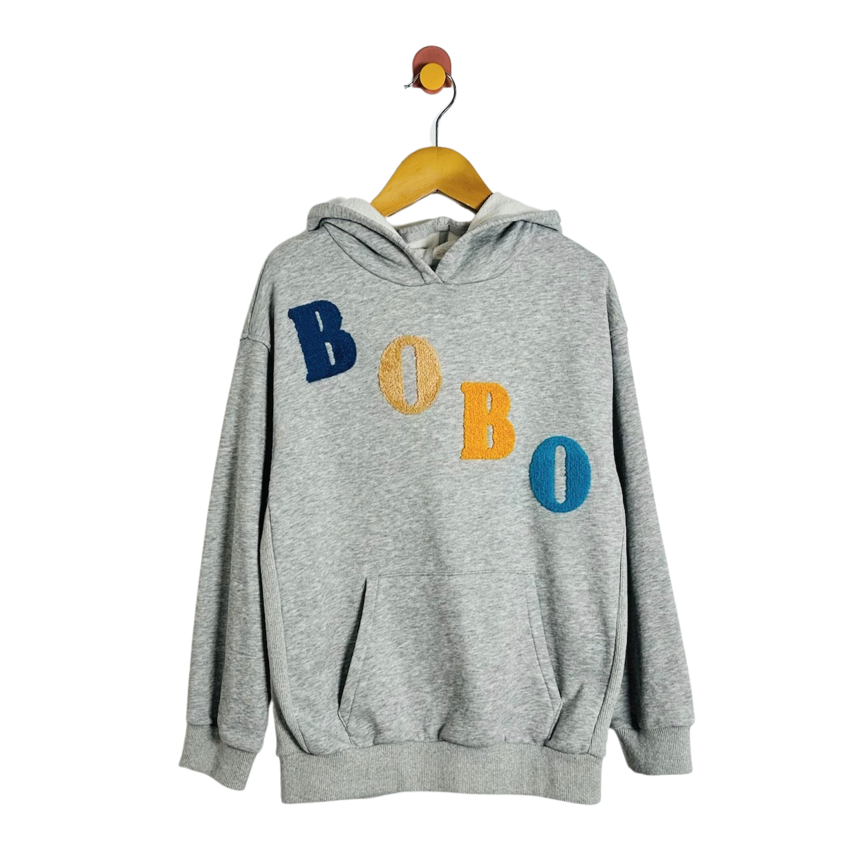 A heather gray pullover hoodie hanging on a wooden hanger against a plain white background. The hoodie features the word 'BOBO' embroidered across the chest in alternating blue, yellow, and blue lettering.