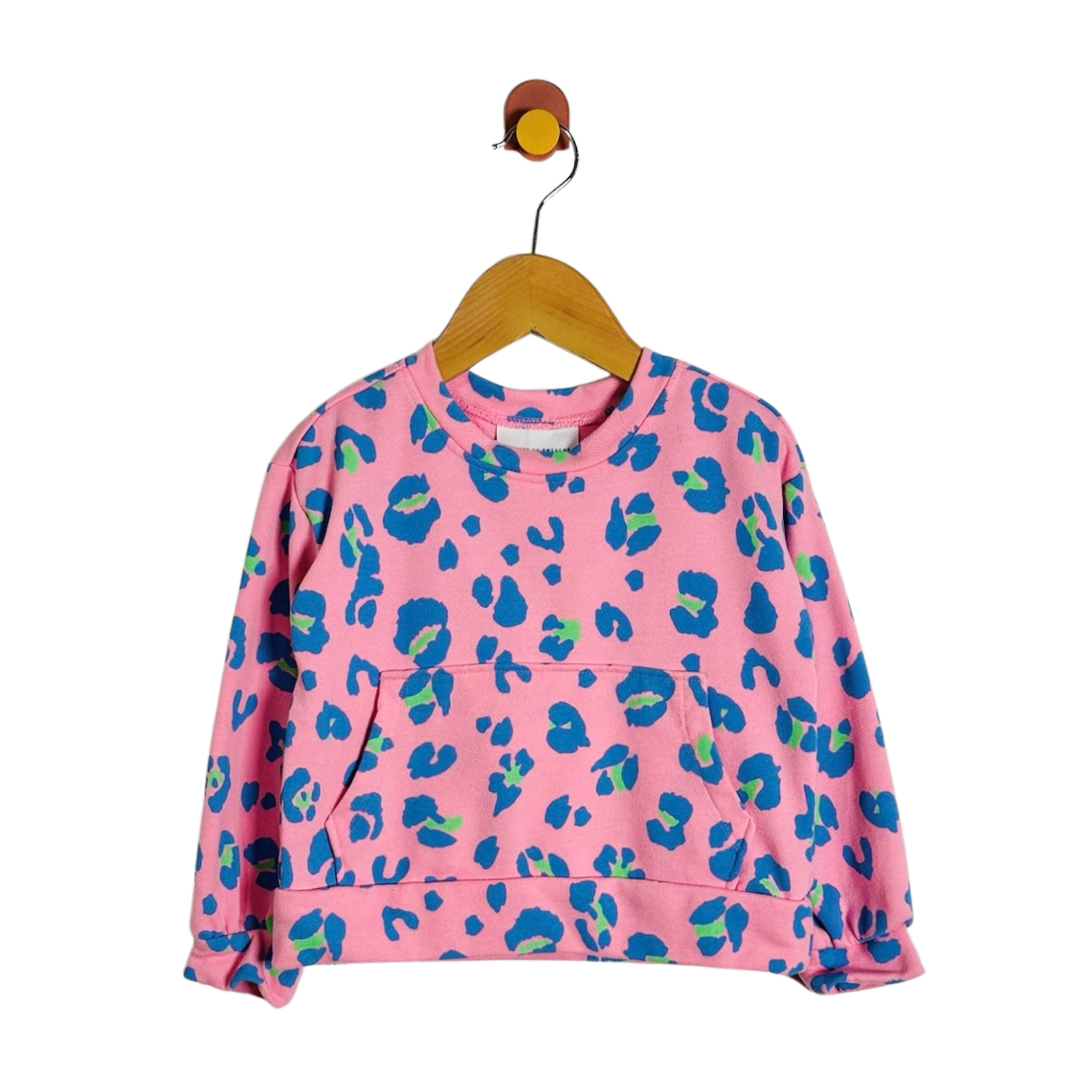 A pink long-sleeve sweatshirt with a blue and green abstract leopard print, hanging on a wooden hanger against a plain white background.