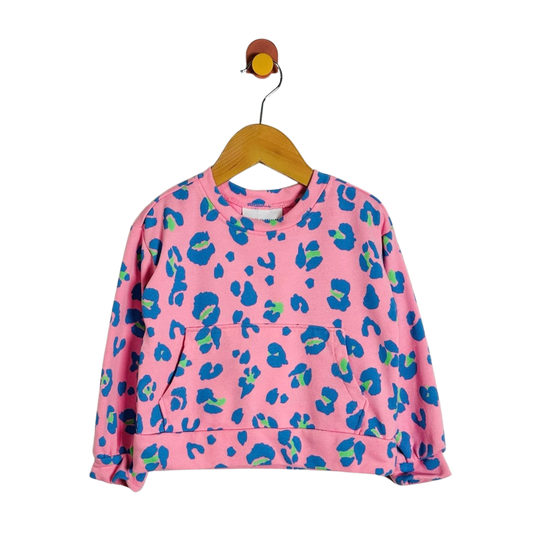 A pink long-sleeve sweatshirt with a blue and green abstract leopard print, hanging on a wooden hanger against a plain white background.