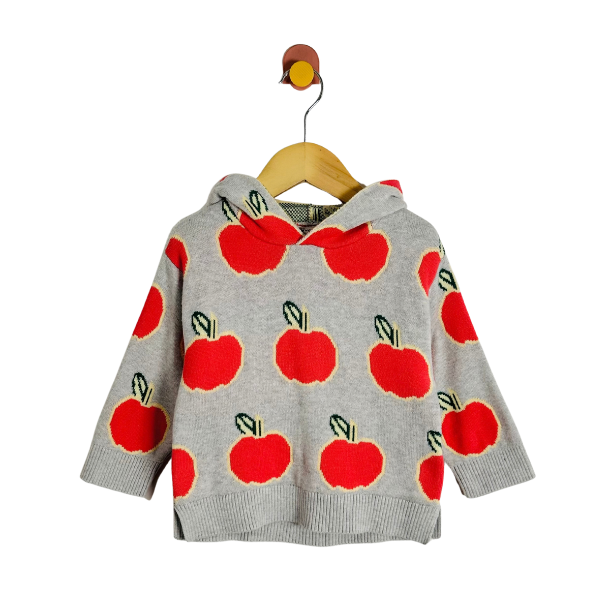 A light gray knit hoodie with a red apple print, hanging on a wooden hanger with a small yellow bird ornament against a plain white background.