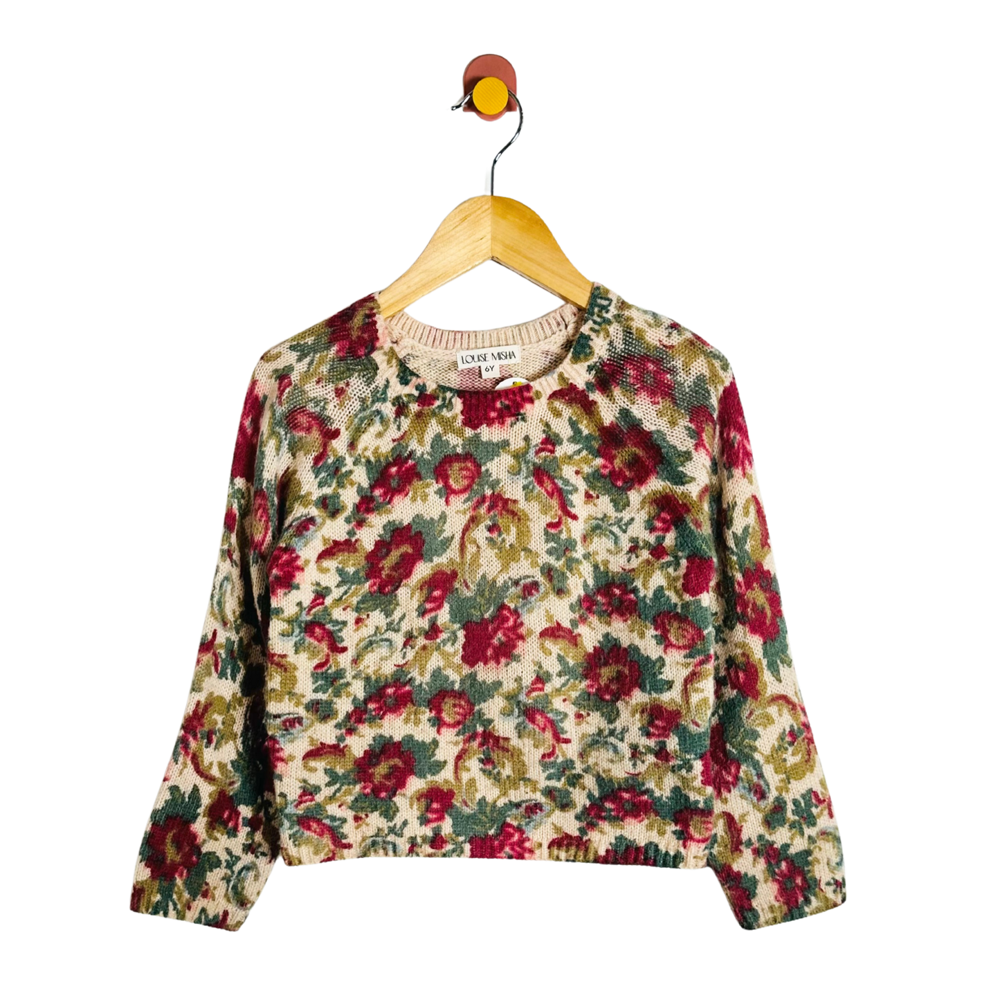 Floral-patterned sweater on a hanger against a white background