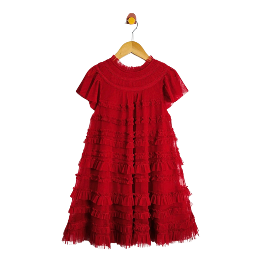A red tiered tulle dress with short flutter sleeves and a smocked neckline, hanging on a wooden hanger against a plain white background.