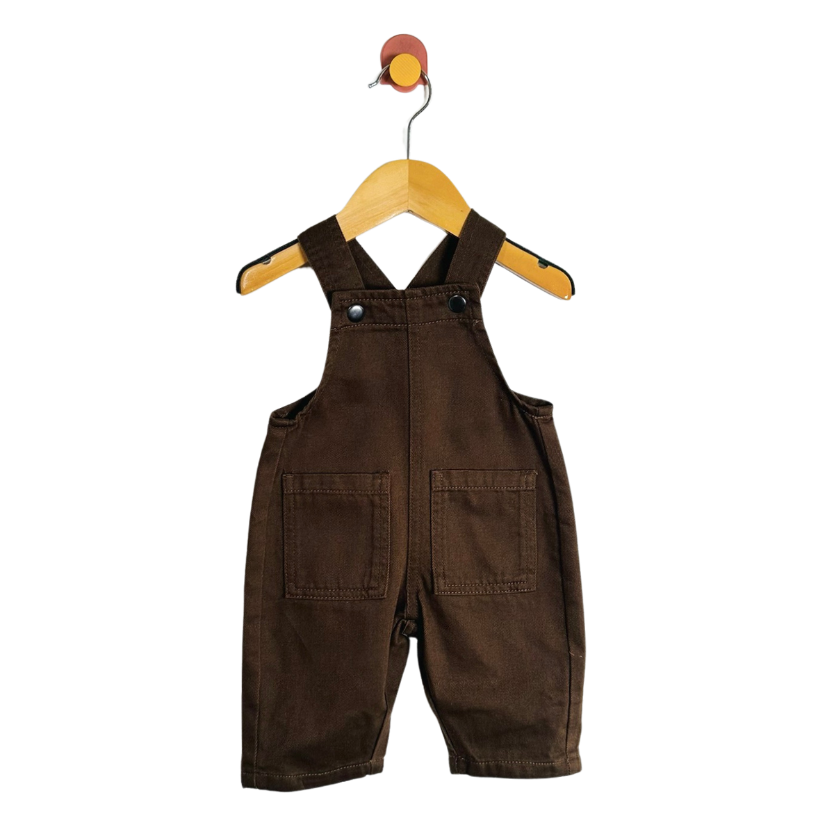 A baby romper in dark brown corduroy fabric, hanging on a wooden hanger against a solid white background.
