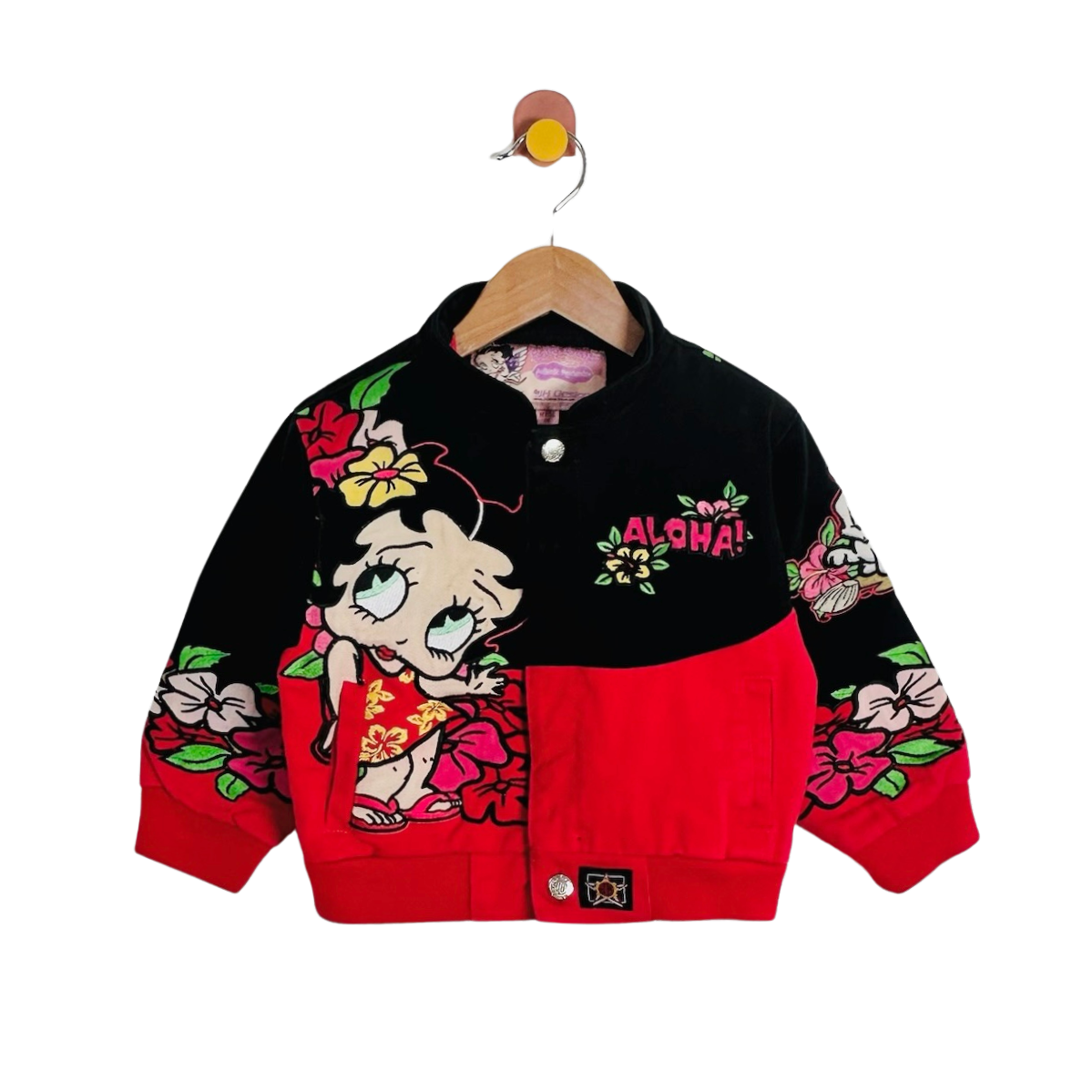 A children's bomber jacket hanging on a wooden hanger against a plain white background. The jacket is black on the upper body and sleeves, with a bright red lower front panel and cuffs.
