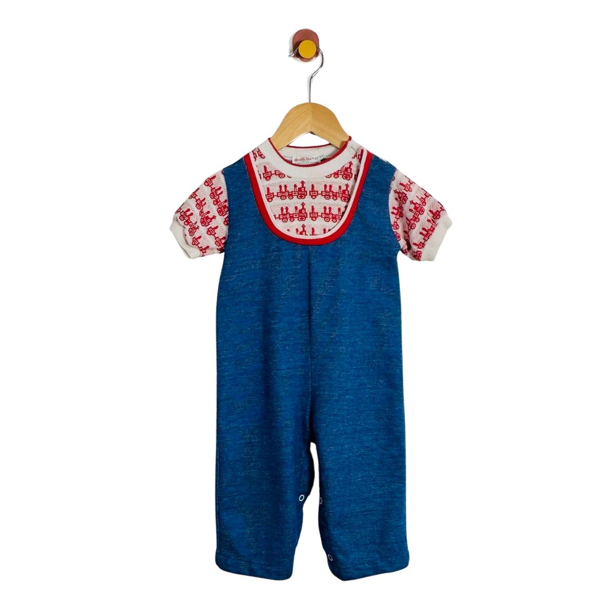 A baby short-sleeve overall romper in blue denim-like fabric, featuring a white embroidered yoke with red trim and matching red-and-white embroidered sleeves, hanging on a wooden hanger against a plain white background.