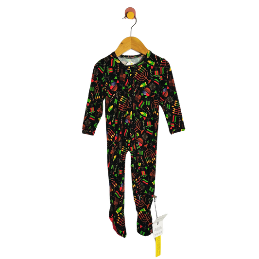 Children's onesie with colorful patterns on a hanger against a white background