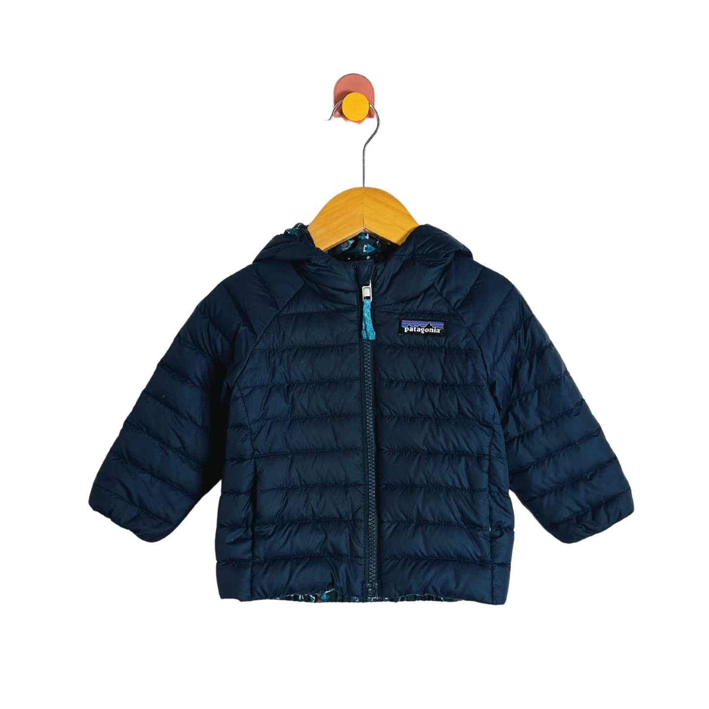 Blue puffer jacket on a hanger with a white background