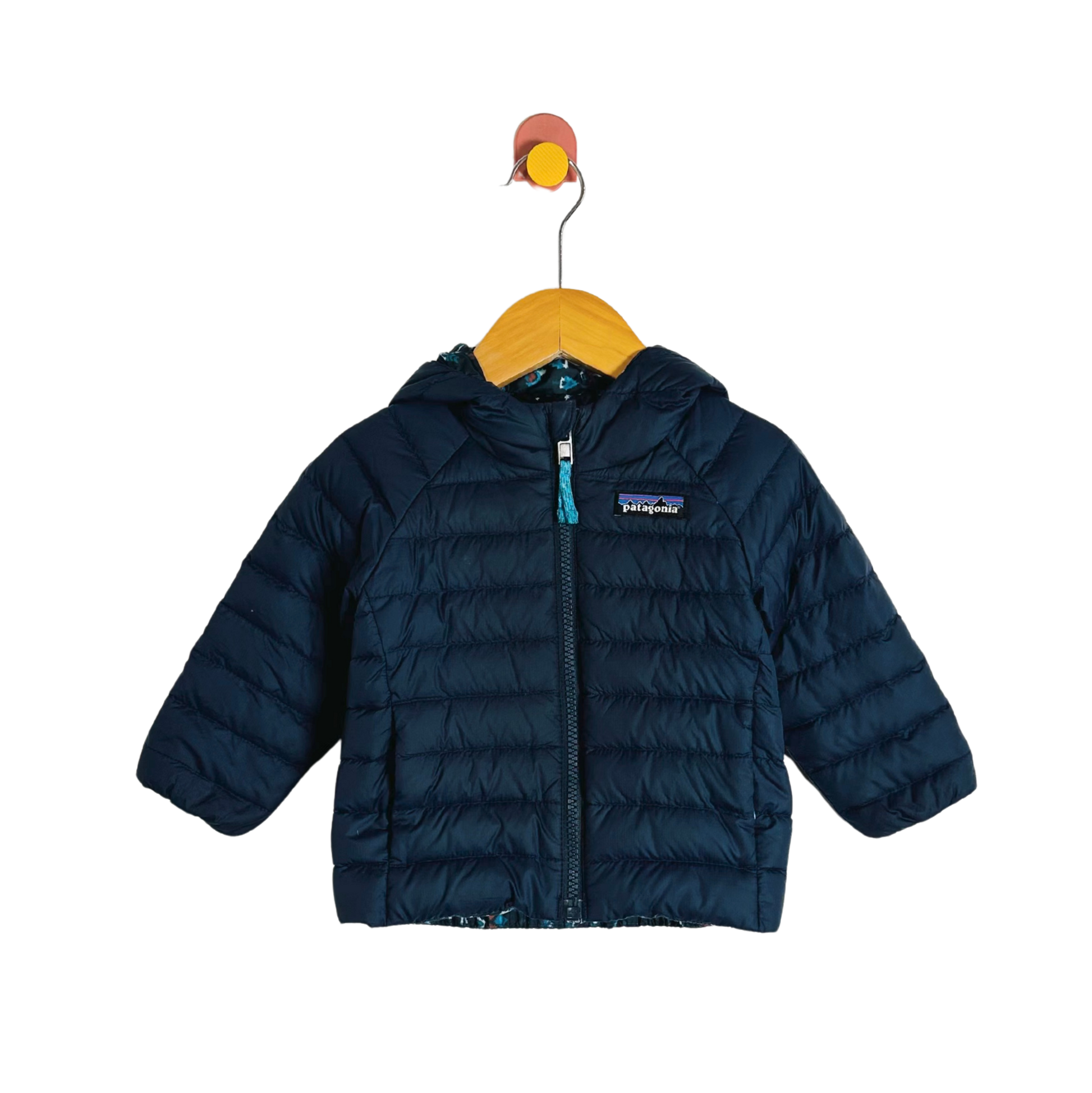 Blue puffer jacket on a hanger with a white background