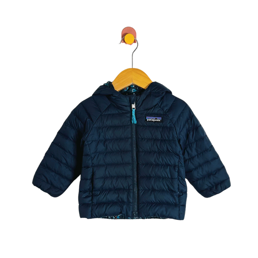 Blue puffer jacket on a hanger with a white background