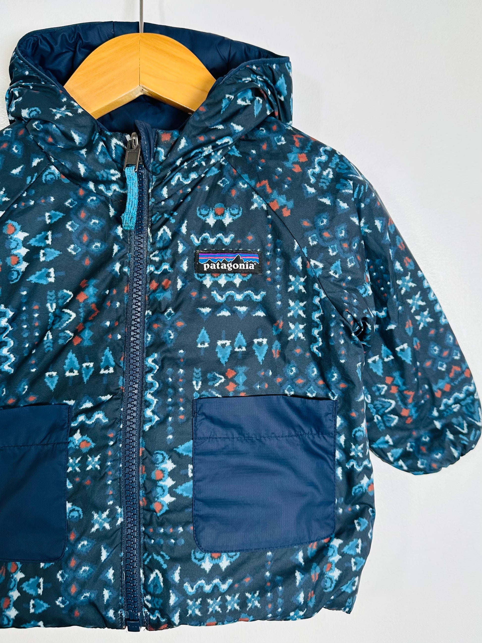 Children's blue patterned jacket with a Patagonia logo on a white background
