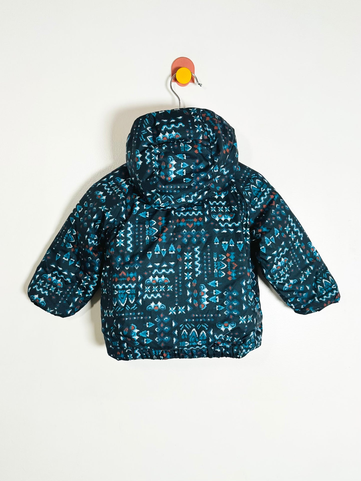 Children's blue patterned jacket on a white background