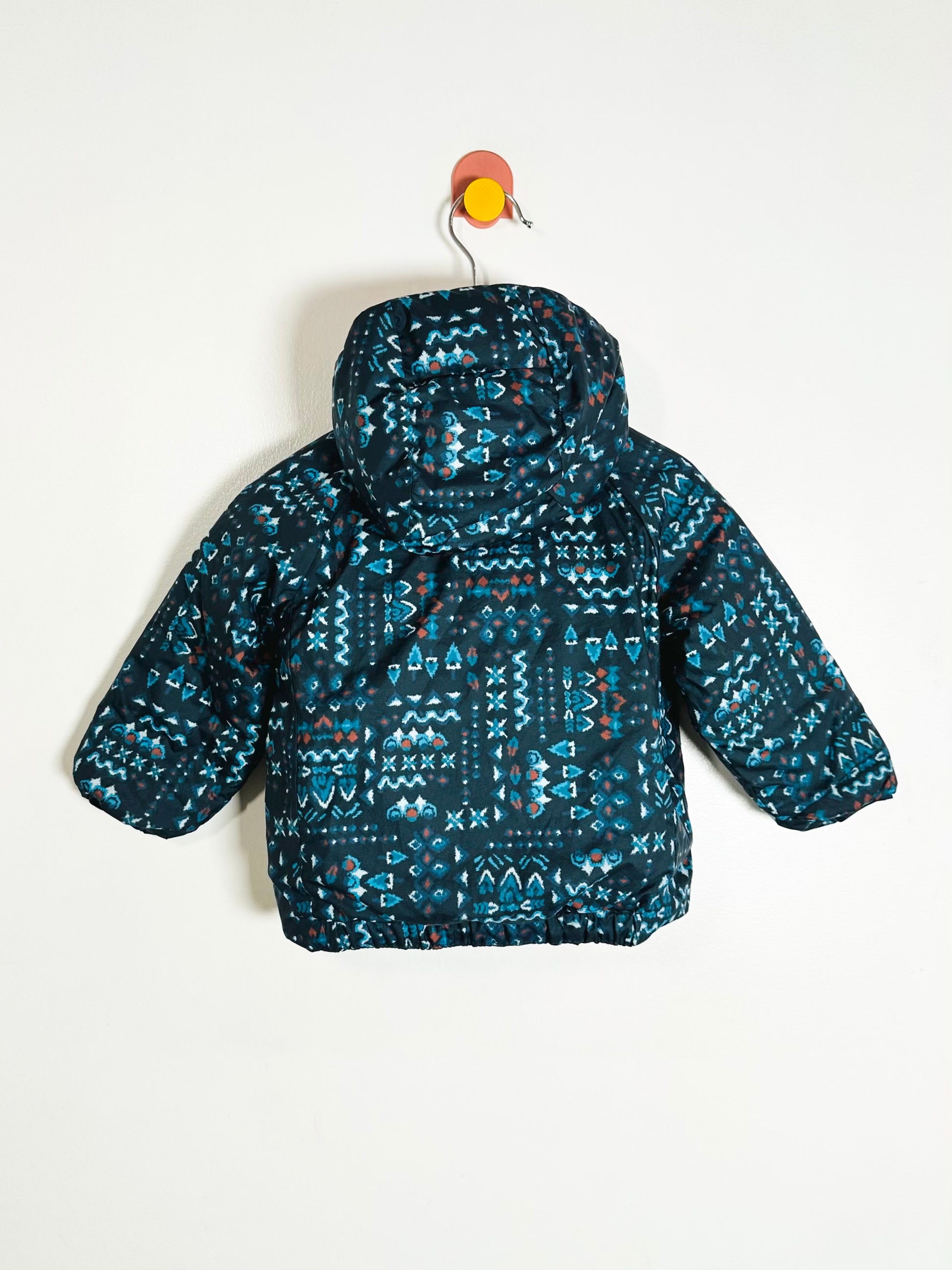 Children's blue patterned jacket on a white background