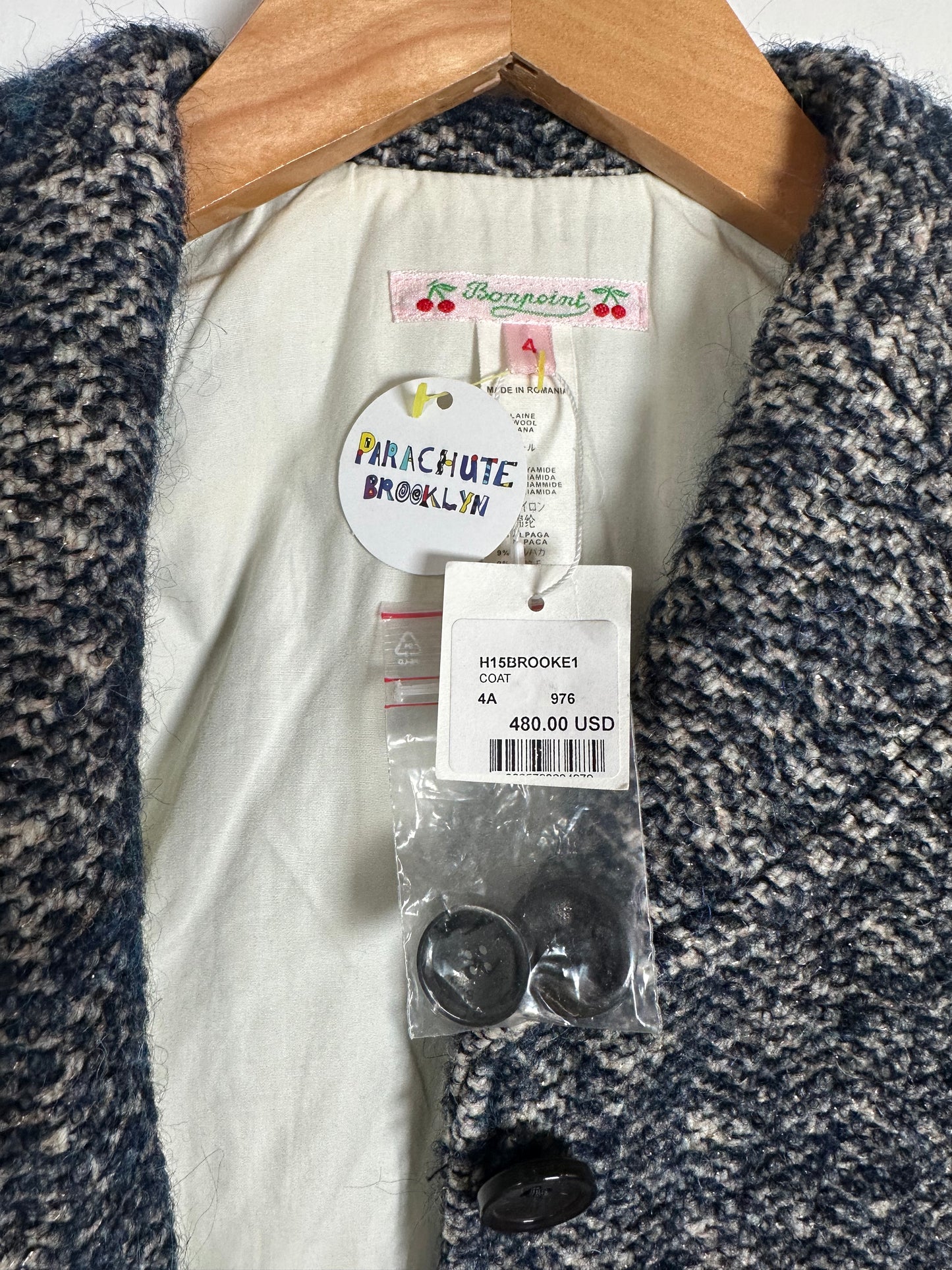 Close-up of a product with tags and packaging on a textured fabric background