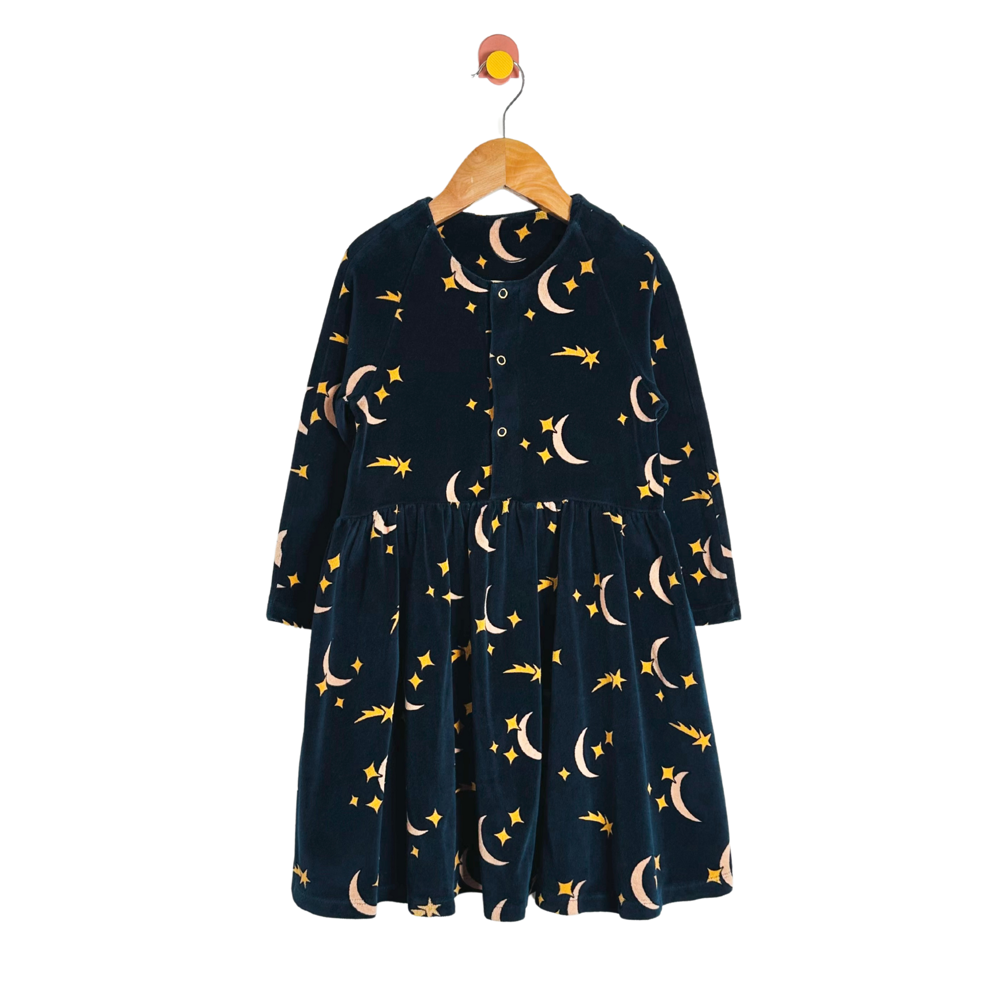 Navy blue dress with celestial pattern on a hanger against a white background