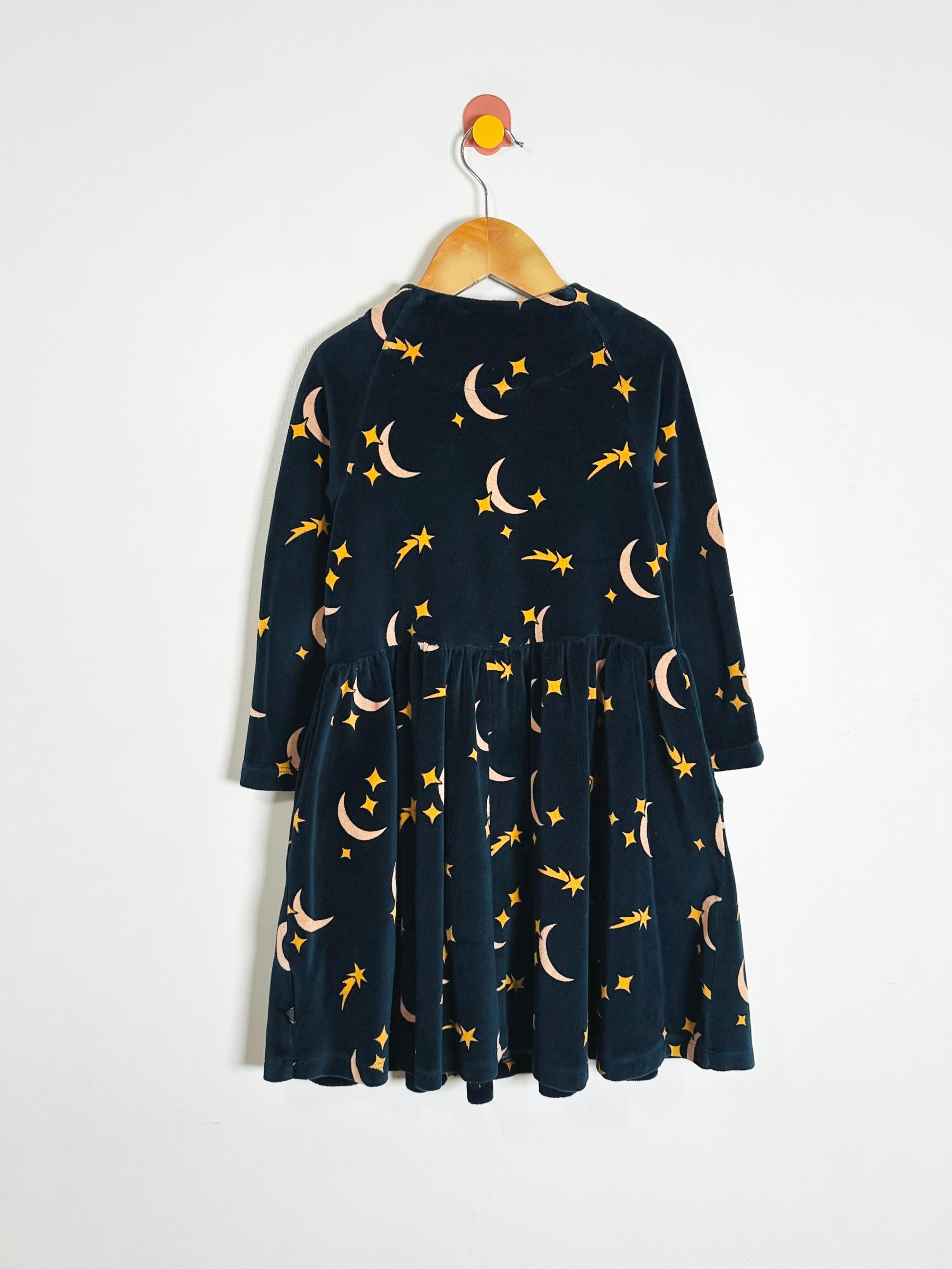 Navy blue dress with celestial pattern on a white background
