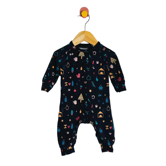 Black baby onesie with colorful patterns on a hanger against a white background