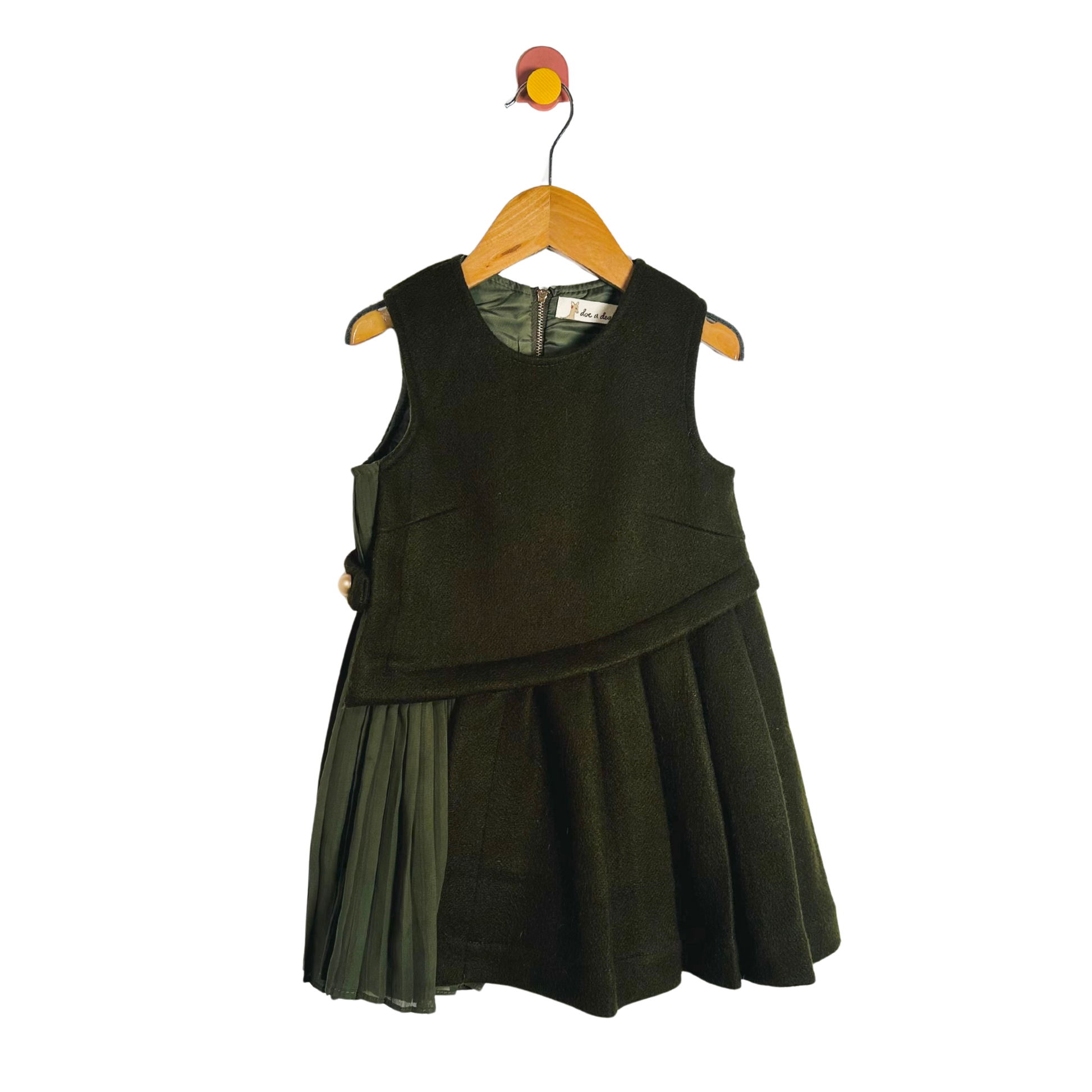 Green dress on a hanger against a white background