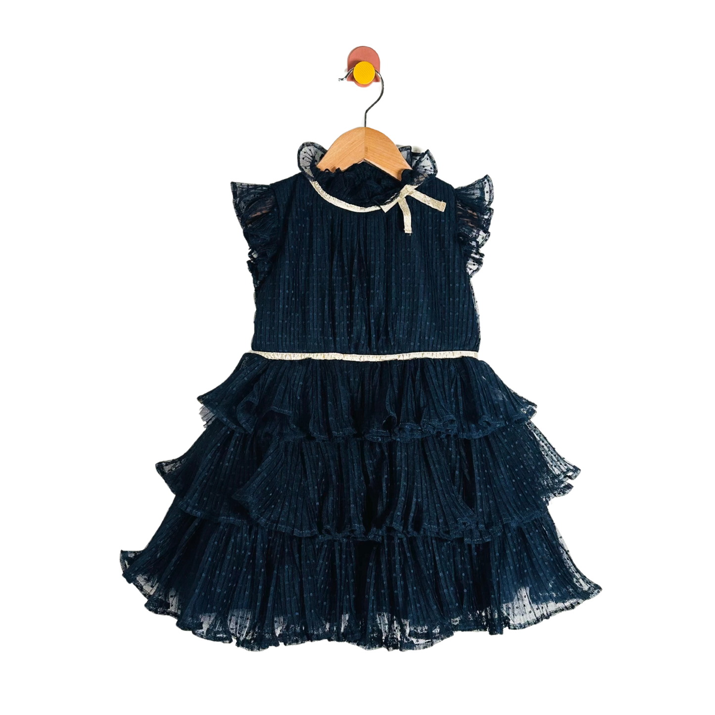 Navy blue ruffled dress on a wooden hanger against a white background