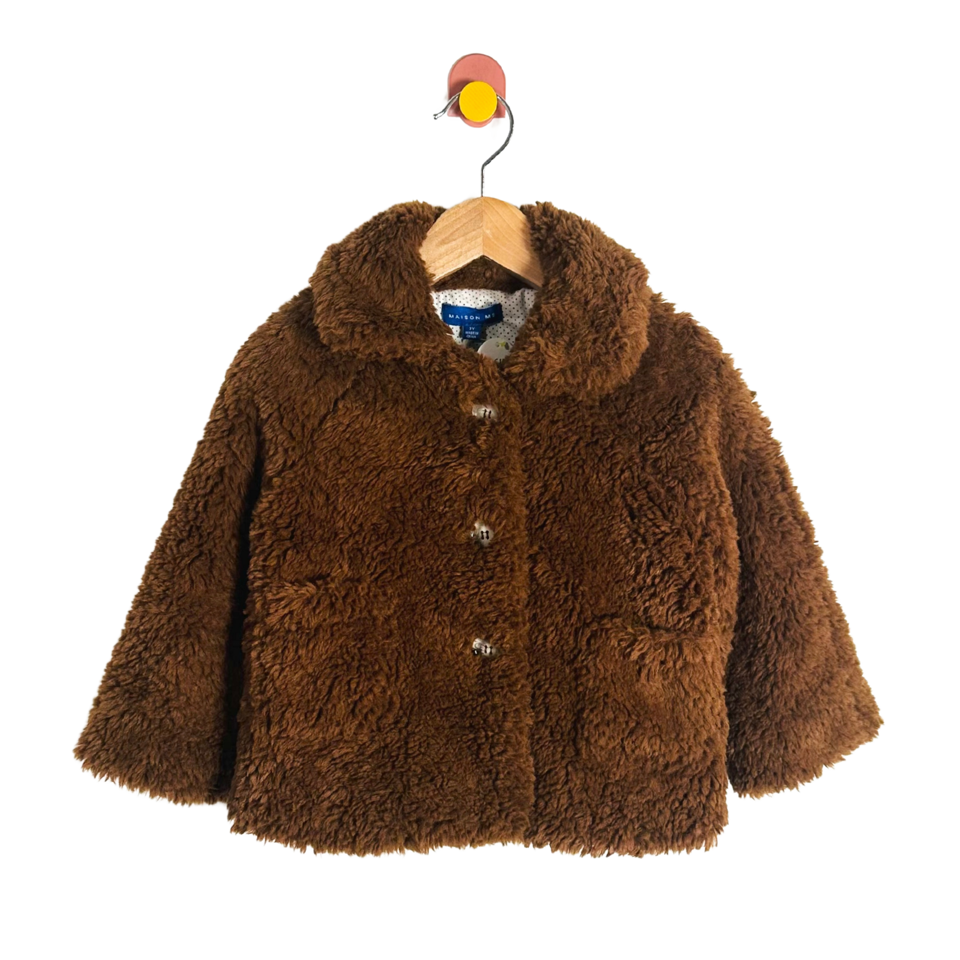 Brown fluffy jacket on a hanger with a white background