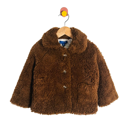 Brown fluffy jacket on a hanger with a white background