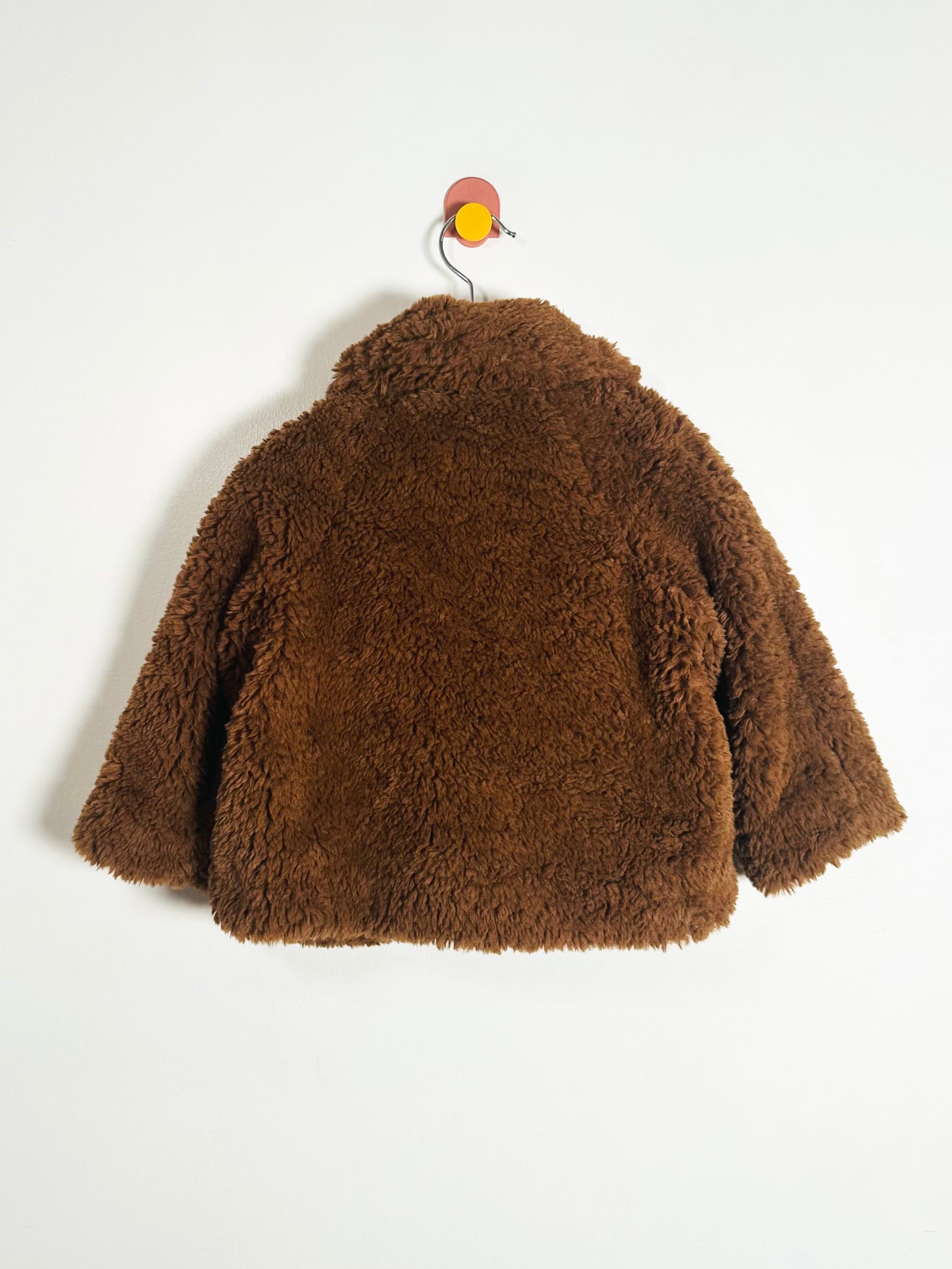 Brown fluffy jacket on a white background