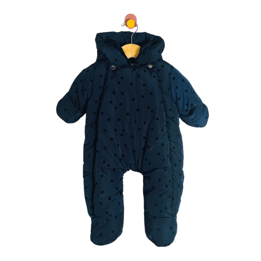 Navy blue baby snowsuit with polka dots on a white background