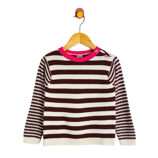 Striped sweater with pink neckline on a hanger against a white background