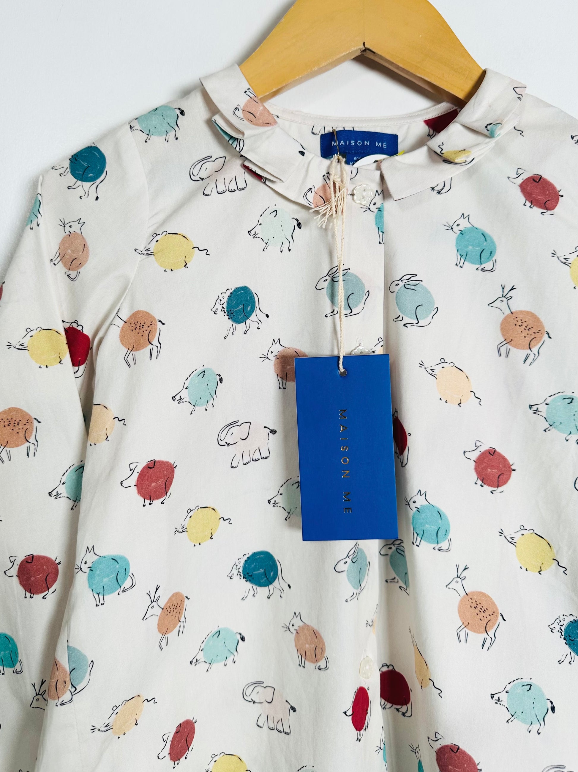 Children's shirt with animal pattern on a hanger