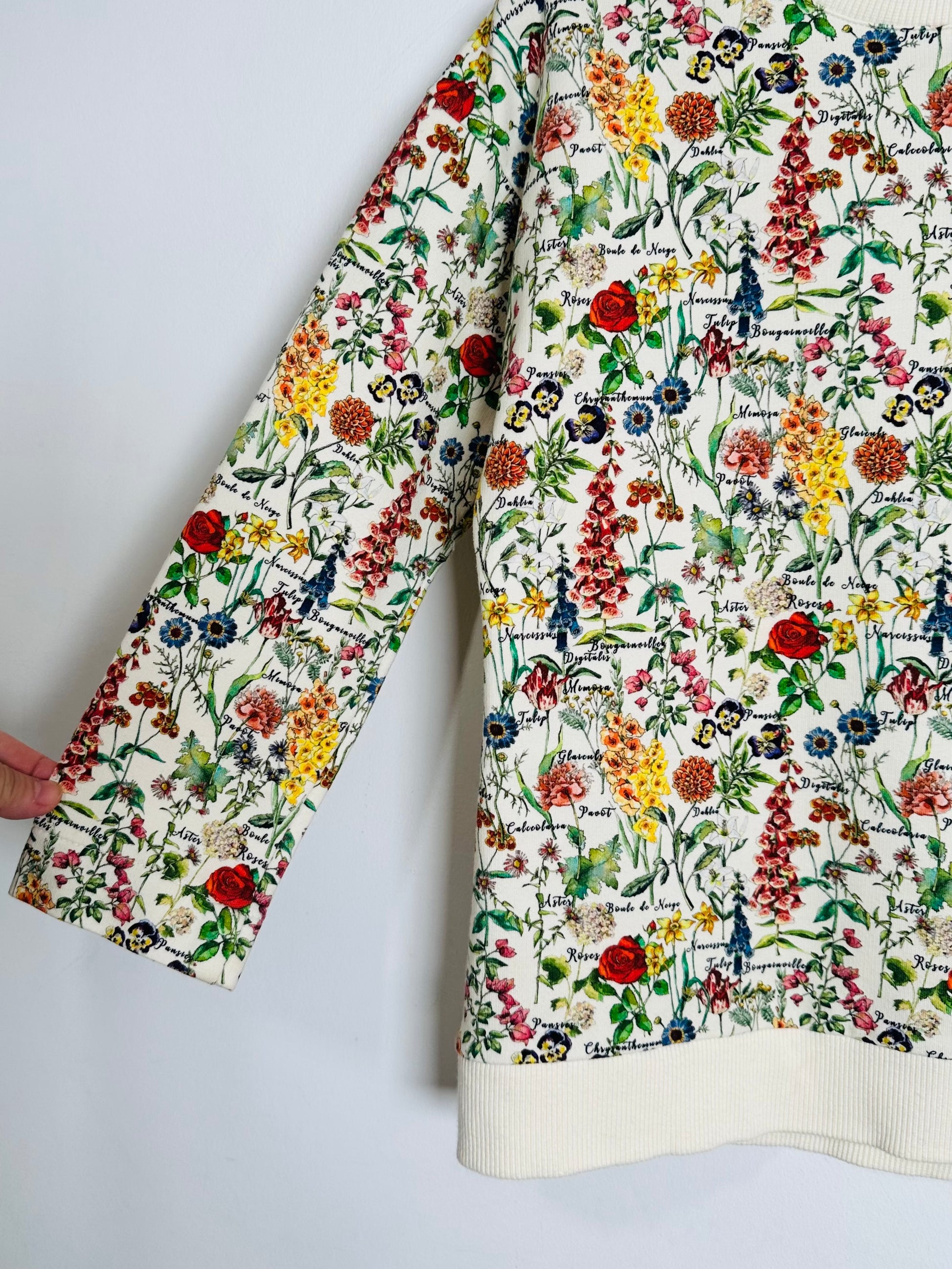 Floral patterned garment with text on a plain background