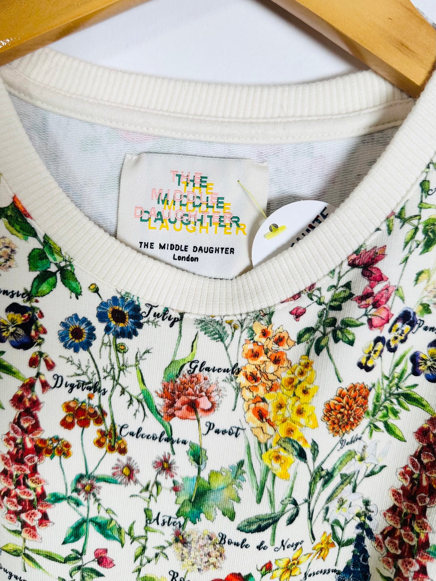 Floral-patterned garment with brand label on a white background