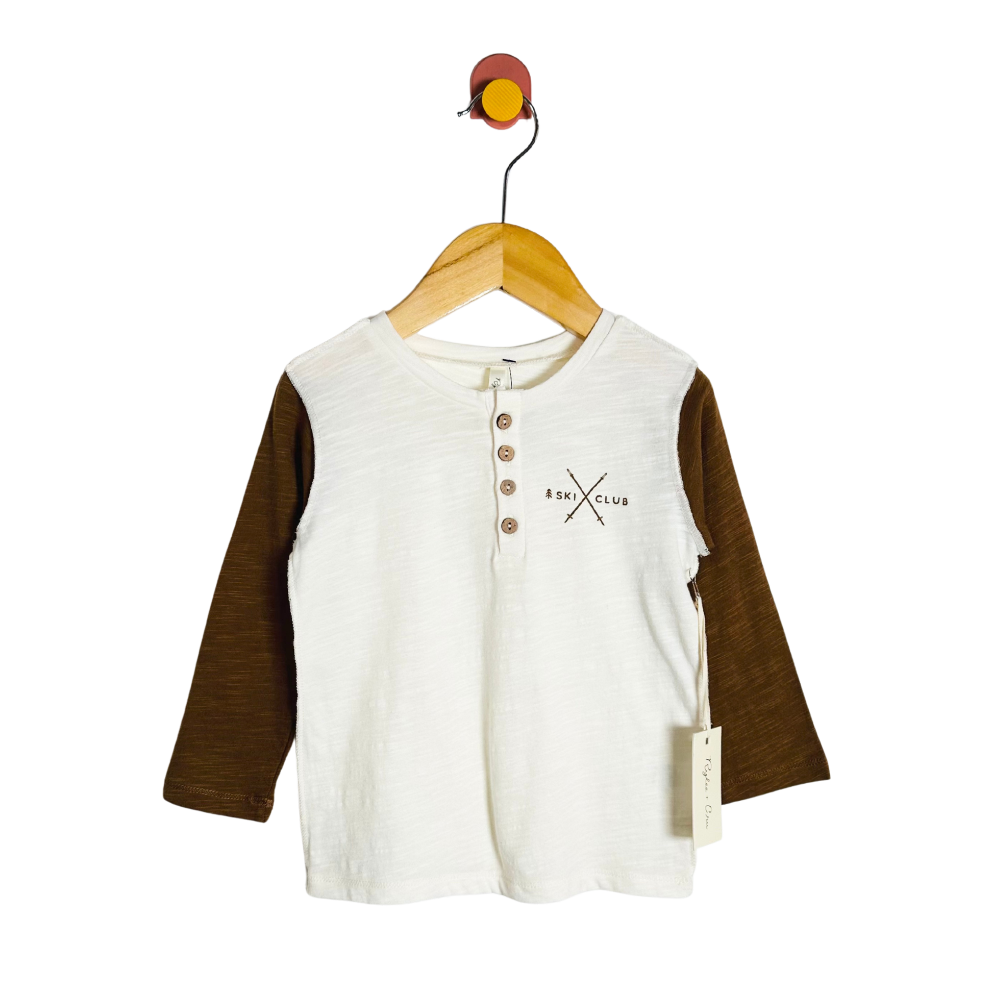 Children's shirt with brown sleeves on a hanger against a white background