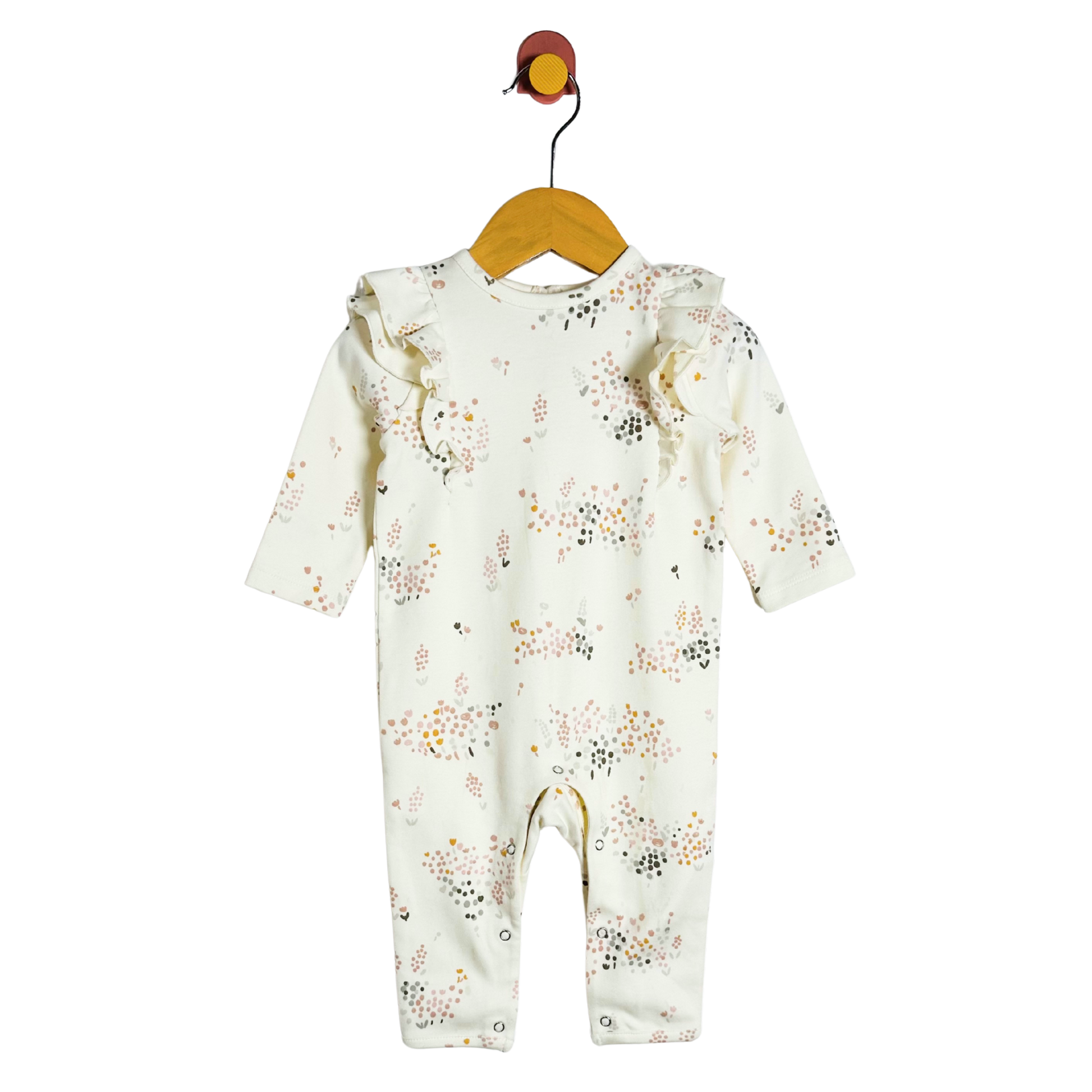 Baby onesie with floral pattern on a hanger against a white background