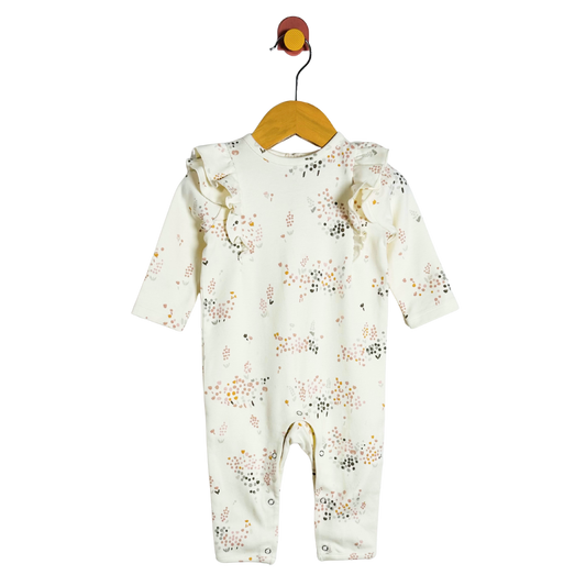 Baby onesie with floral pattern on a hanger against a white background