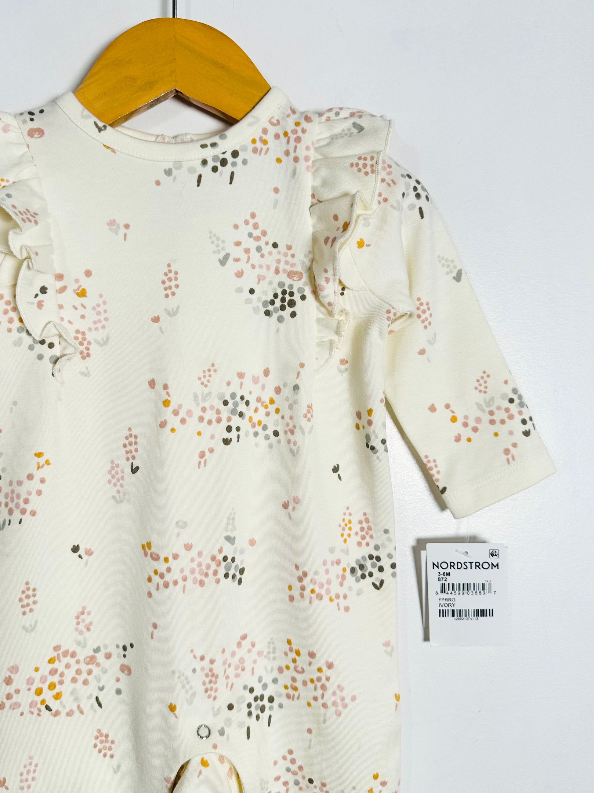 Floral-patterned dress on a hanger with a Nordstrom tag.